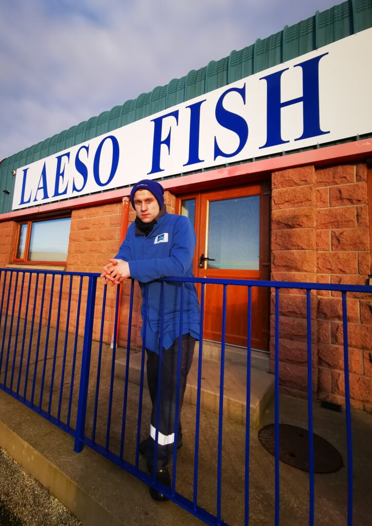 Seafood worker stood outside processing factory