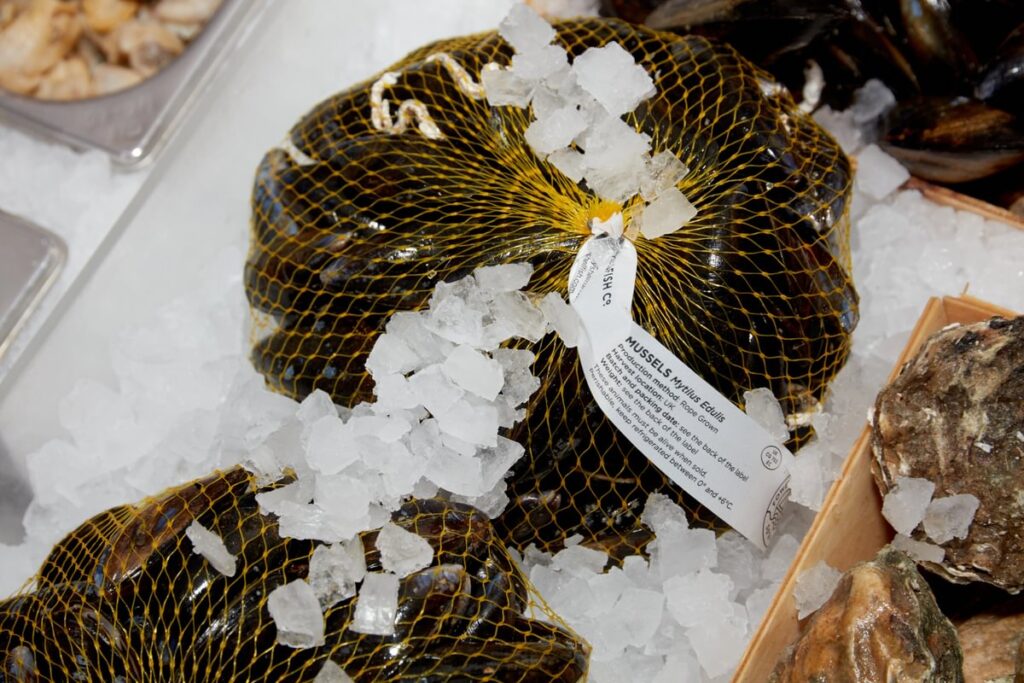 bagged mussels on a bed of crushed ice