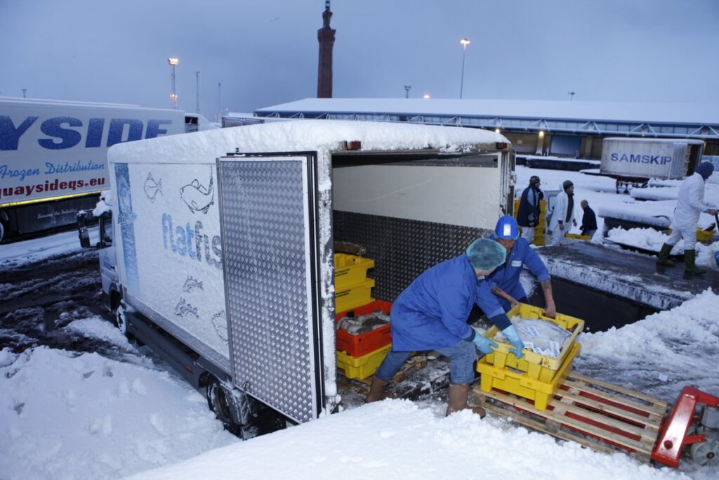 Image of truck being loaded - winter shot as snow on ground