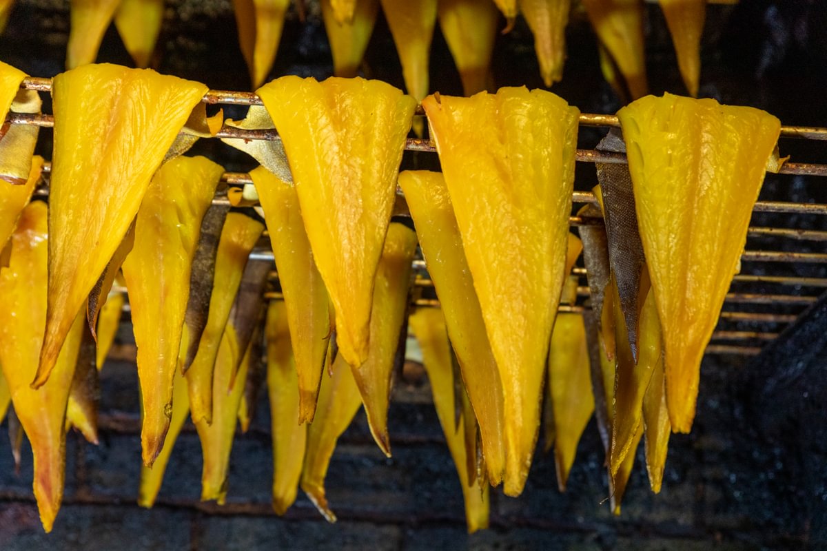 Smoked fish hanging from rods